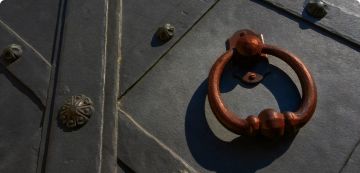 Brass door handle on a fortified black door